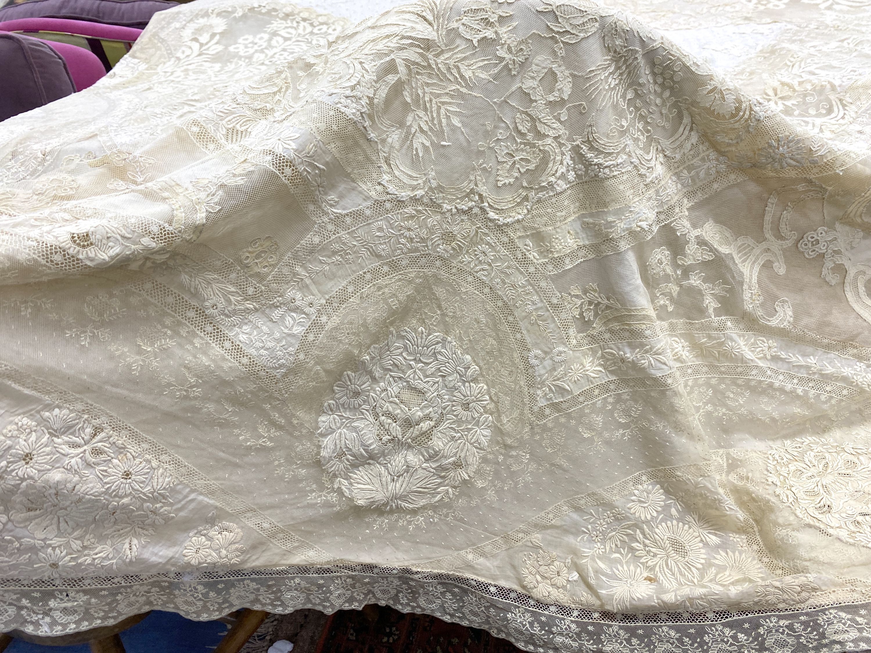 An Edwardian hand made lace bedspread. Hand sewn using finely spun lawn, decorated with Carrickmacross and white work embroidery, edged in bobbin lace. Possibly made as part of a trousseau.